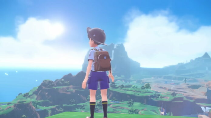 A young trainer standing in front of a landscape.